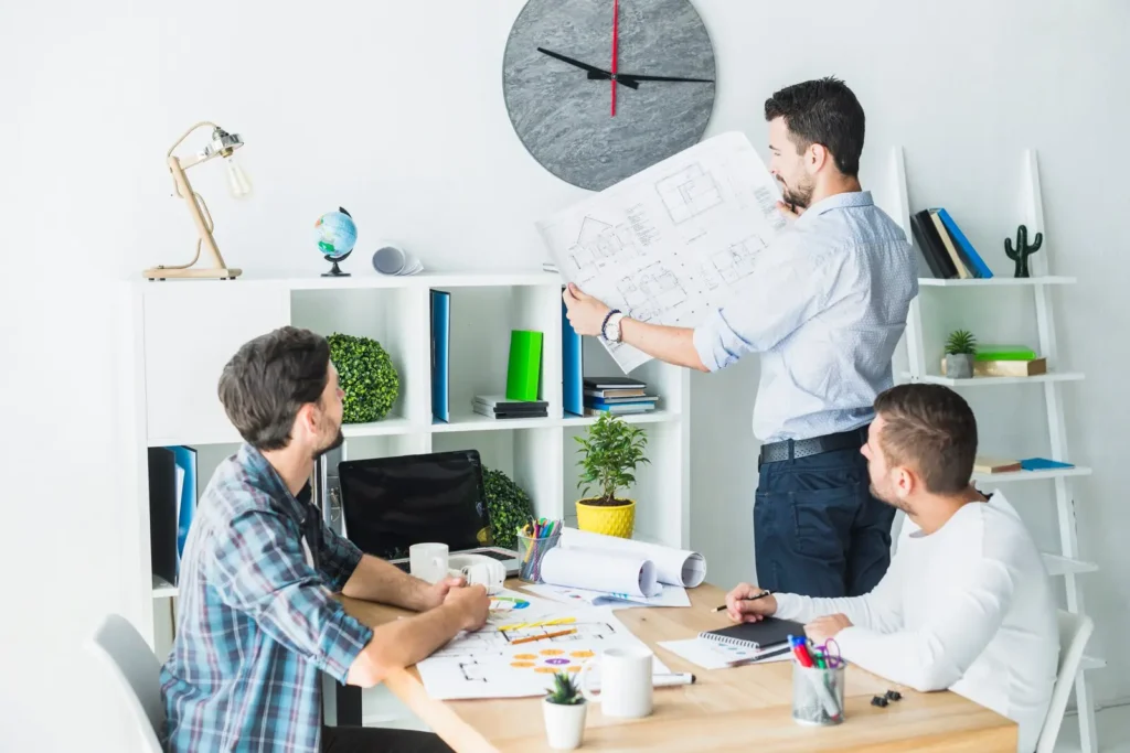 architect showing blueprint his colleagues 23 2147839899