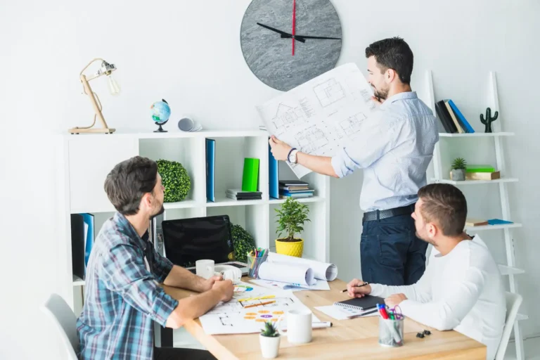 architect-showing-blueprint-his-colleagues_23-2147839899