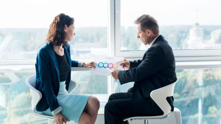 businessman-explaining-chart-his-female-colleague_23-2147899674
