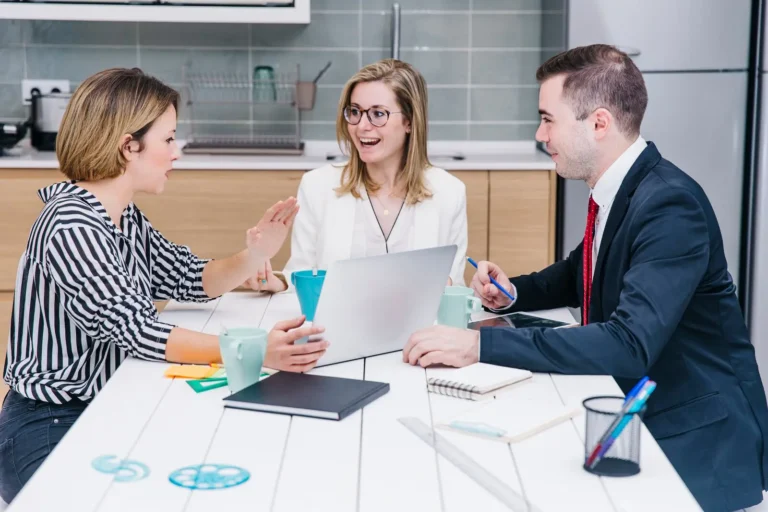 cheerful-colleagues-using-devices_23-2147787550