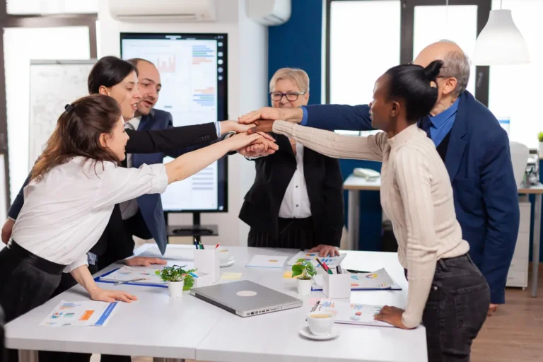 cheerful-overjoyed-business-people-conference-room-celerating-diverse-colleagues-with-new-opportunity-enjoing-victory-meeting-broadroom-office_482257-5101
