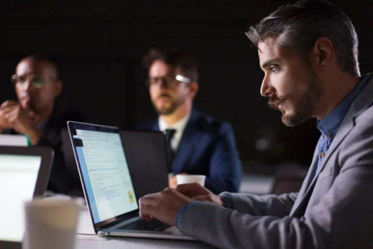 focused-bearded-office-employee-looking-laptop_74855-4203
