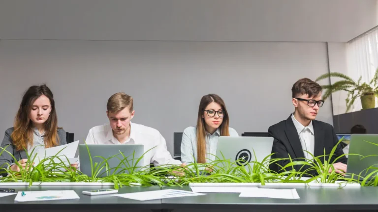 group-young-businesspeople-working-laptop-office_23-2147838549